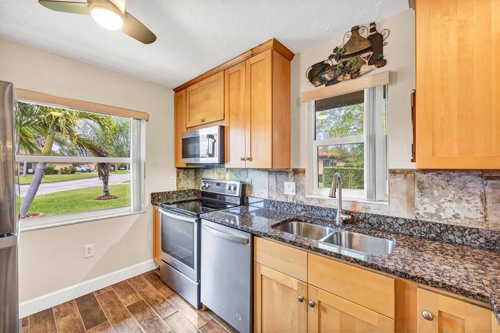 6416 Mercer Road Bradenton, FL 34207 - Photo 12 of 38 a kitchen with granite countertop a sink and a window