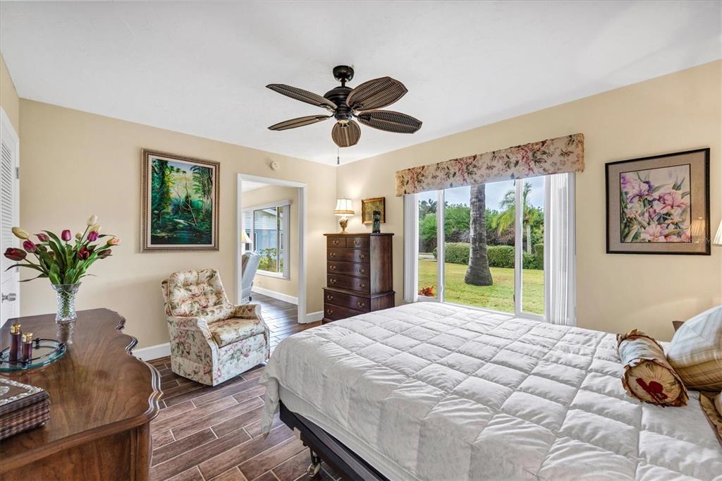 6416 Mercer Road Bradenton, FL 34207 - Photo 16 of 38 a bedroom with a large bed and wooden floor