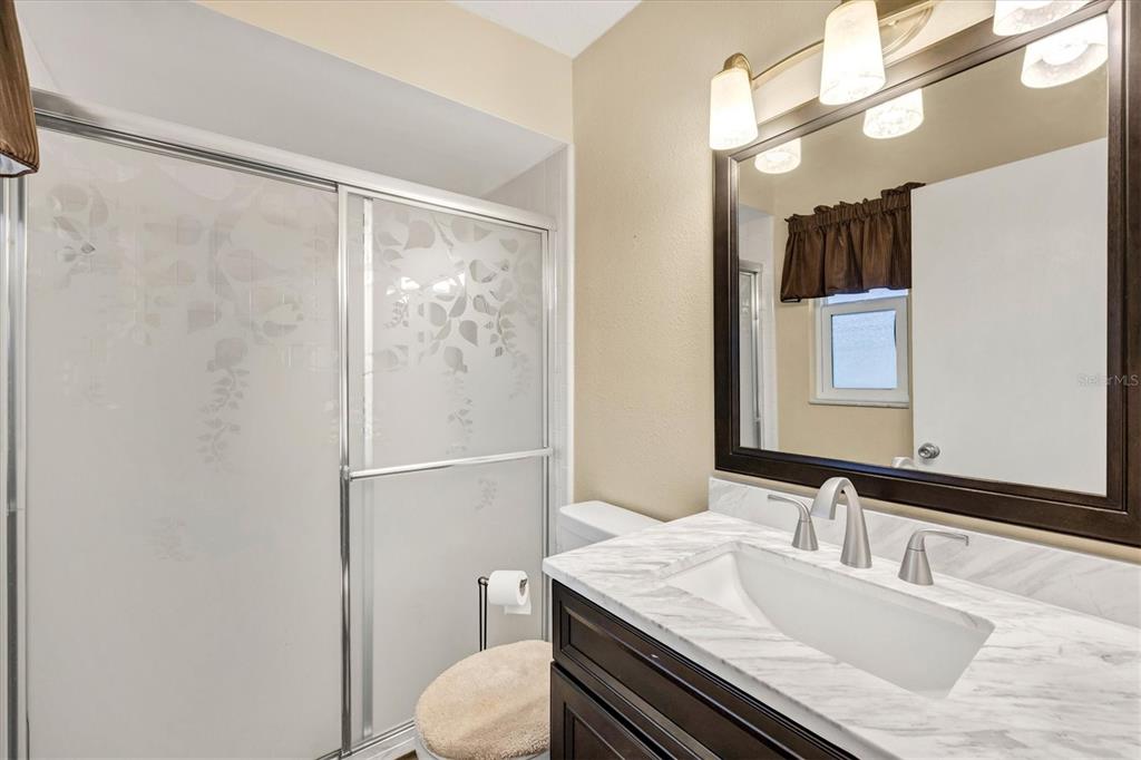 6416 Mercer Road Bradenton, FL 34207 - Photo 17 of 38 a bathroom with a granite countertop sink toilet and shower