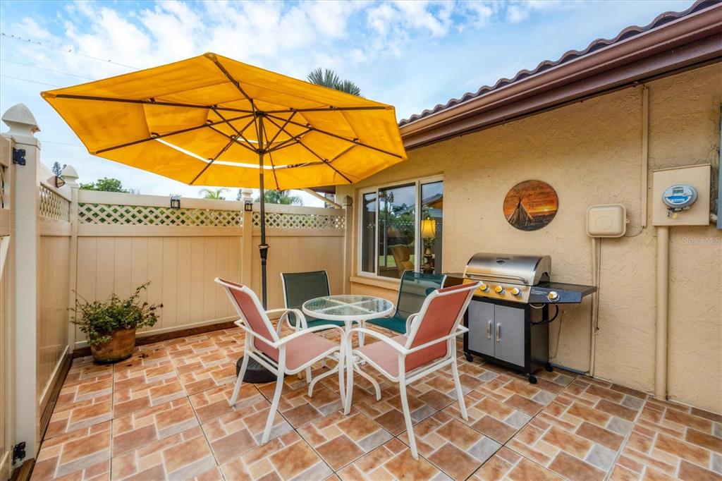 6416 Mercer Road Bradenton, FL 34207 - Photo 23 of 38 a patio with a table and chairs