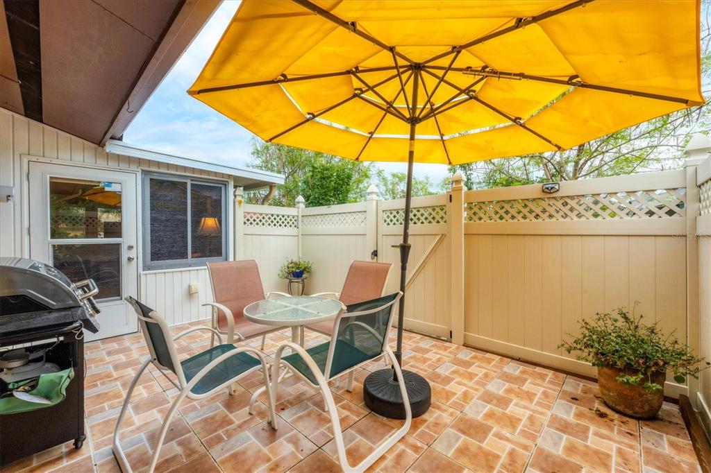 6416 Mercer Road Bradenton, FL 34207 - Photo 24 of 38 a patio with a yard table and chairs