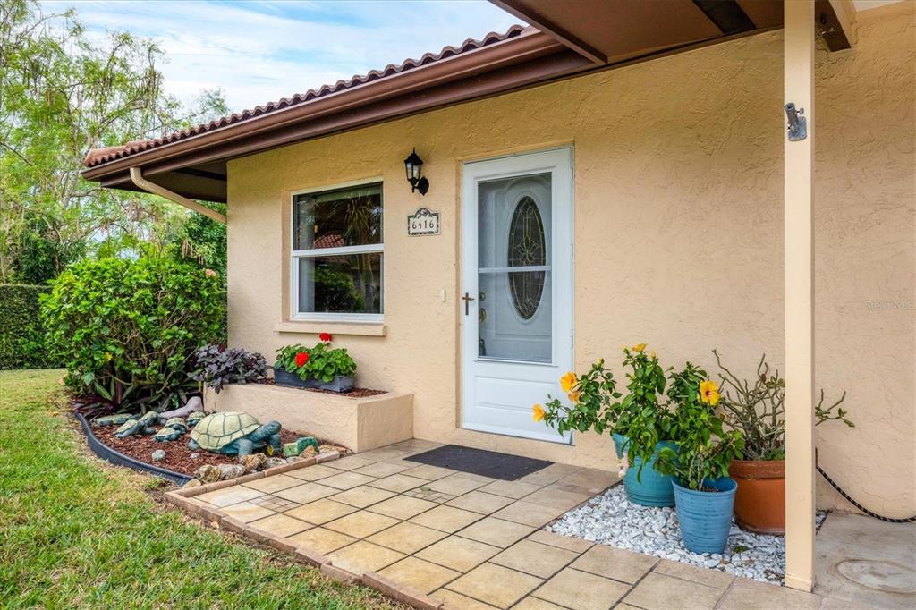 6416 Mercer Road Bradenton, FL 34207 - Photo 3 of 38 a front view of a house with garden