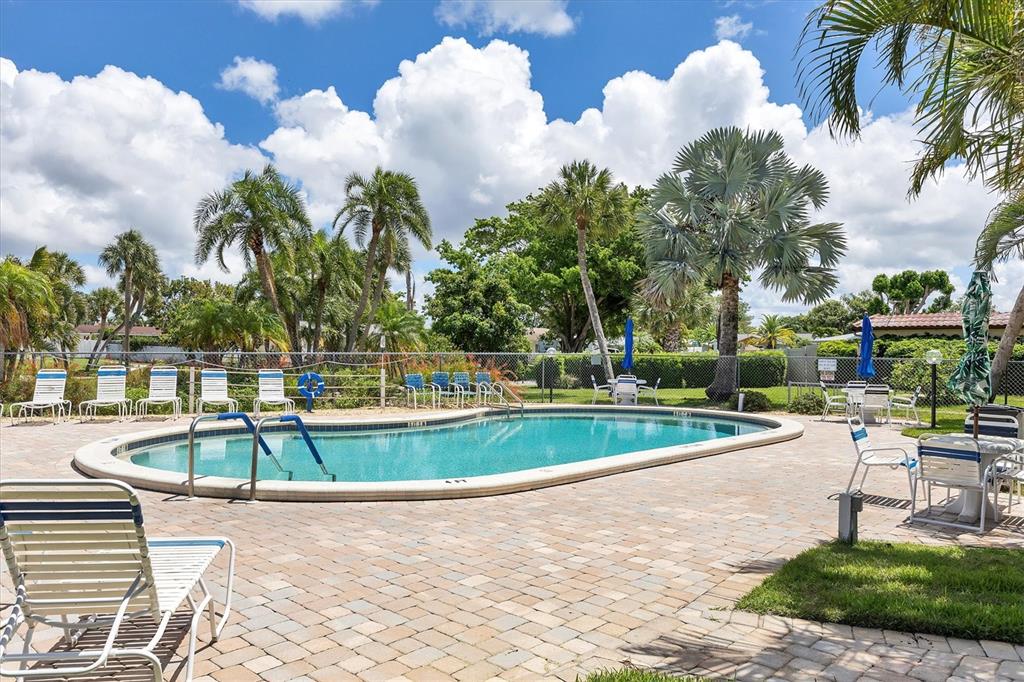 6416 Mercer Road Bradenton, FL 34207 - Photo 32 of 38 a view of a swimming pool with a lounge chairs