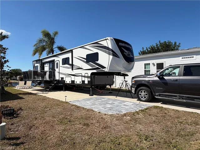 a view of a house with a big yard and large trees