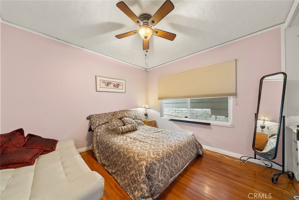 4006 York Boulevard Los Angeles, CA 90065 - Photo 18 of 33 a bedroom with a bed and wooden floor