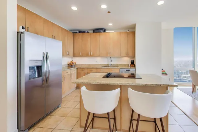 a kitchen with kitchen island a appliances a sink and a refrigerator