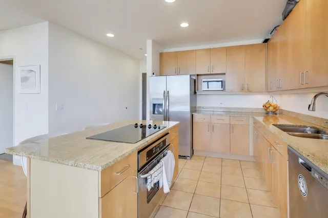 a kitchen that has a sink and a stove in it