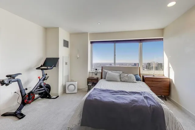a bedroom with a bed and gym equipment