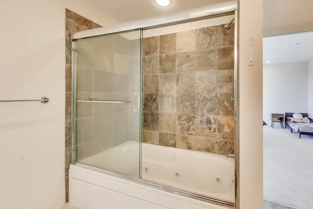 a bathroom with a bathtub and a shower