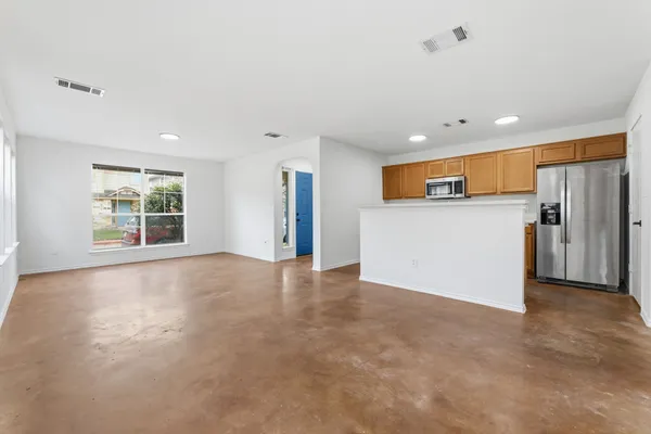 a kitchen with stainless steel appliances granite countertop a sink and a stove