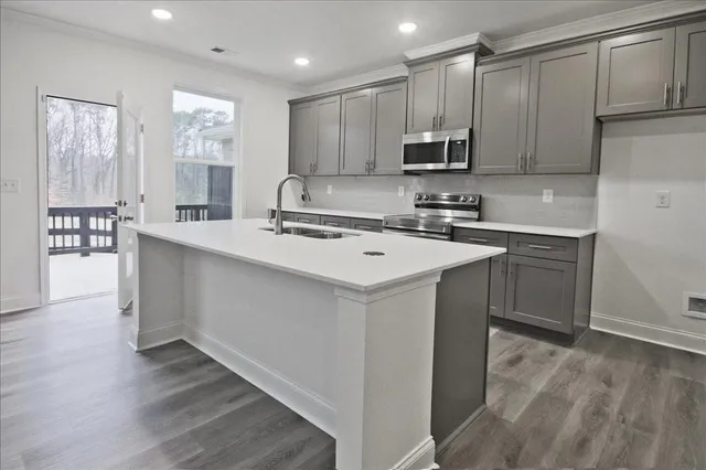a kitchen with a sink a stove a refrigerator and cabinets