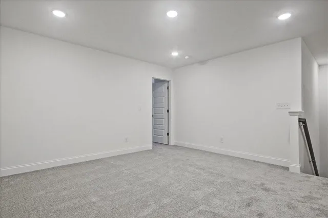 an empty room with a window and a ceiling fan
