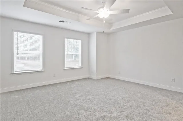 an empty room with a ceiling fan and a window