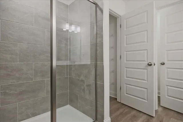 a bathroom with a glass shower door