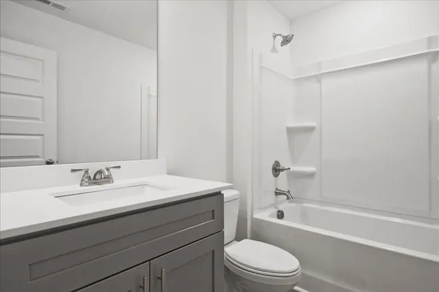 a view of a brick house with a yard