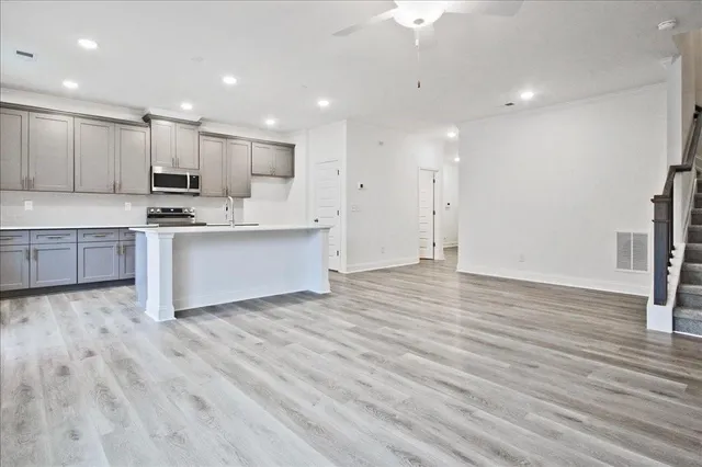 a view of kitchen with wooden floor and electronic appliances