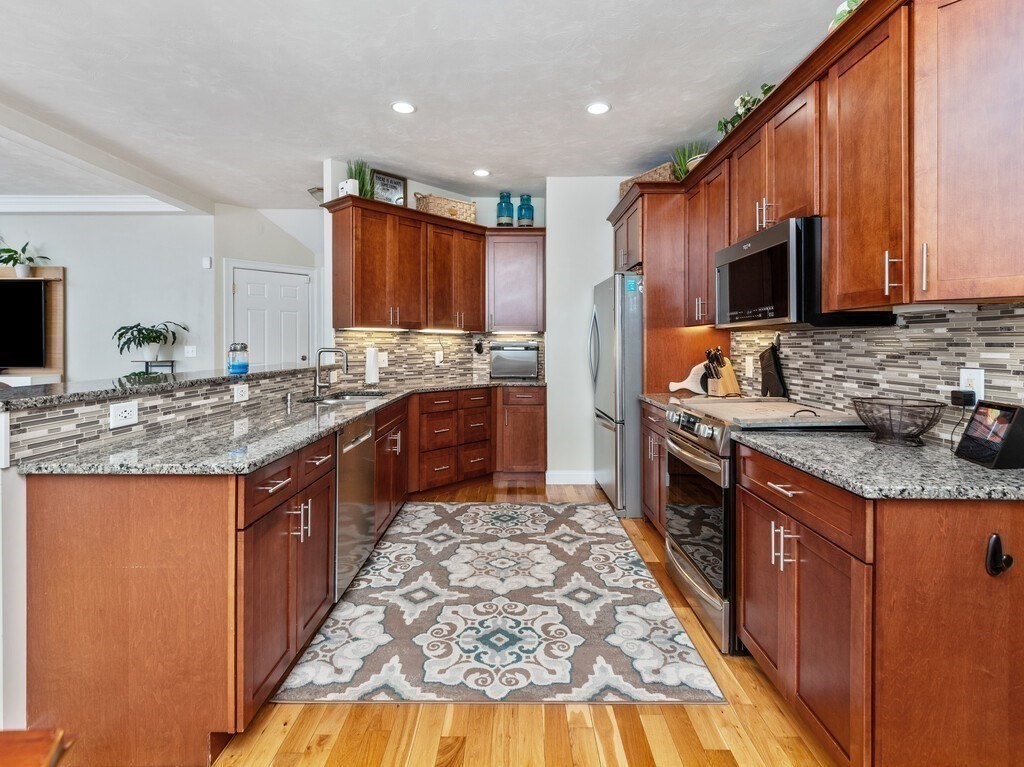 40 Rustic Drive Worcester, MA 01609 - Photo 11 of 39 a kitchen with stainless steel appliances granite countertop a stove a sink and a refrigerator