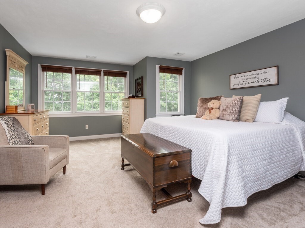 40 Rustic Drive Worcester, MA 01609 - Photo 17 of 39 a bedroom with a bed and a couch next to a window