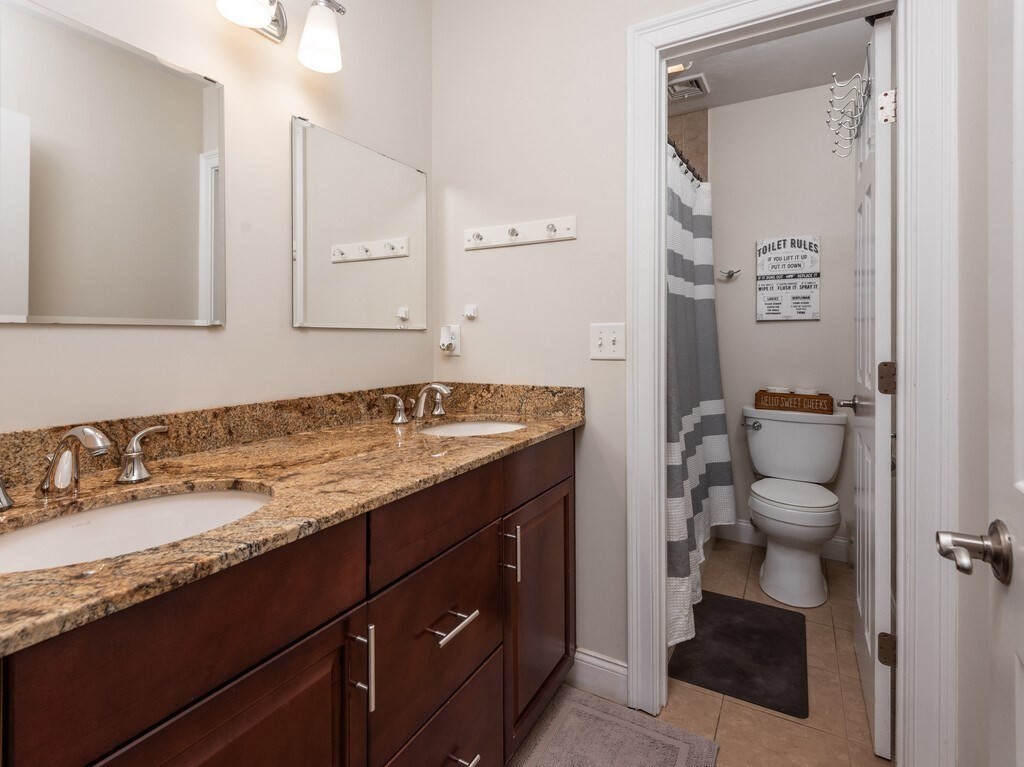 40 Rustic Drive Worcester, MA 01609 - Photo 25 of 39 a bathroom with a granite countertop sink and a mirror
