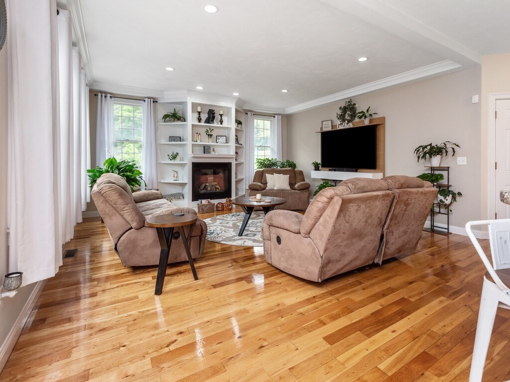 40 Rustic Drive Worcester, MA 01609 - Photo 6 of 39 a living room with furniture a flat screen tv and a fireplace
