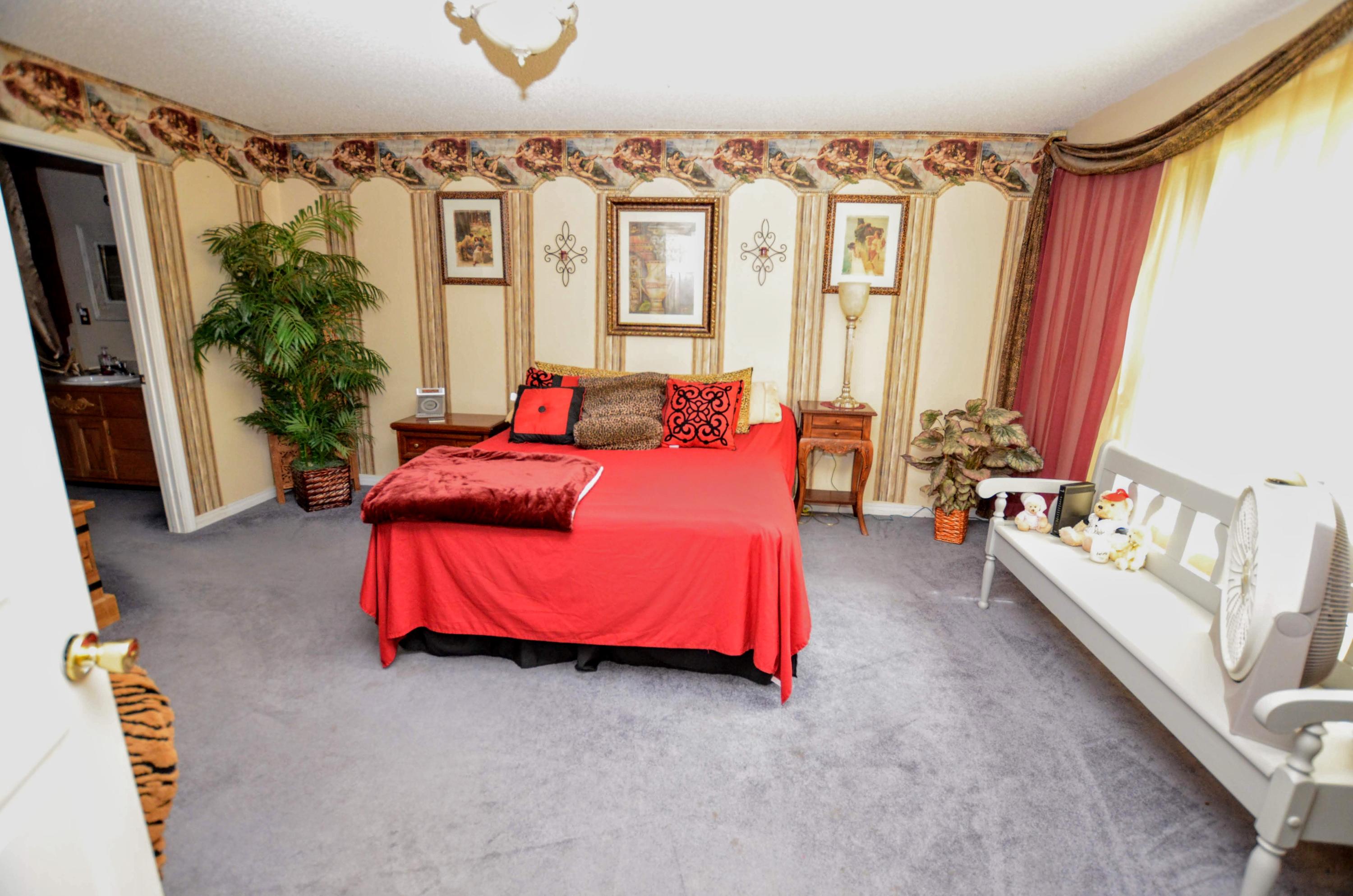 715 Ridge Lake Road Crestview, FL 32536 - Photo 11 of 14 a bedroom with furniture and a large window