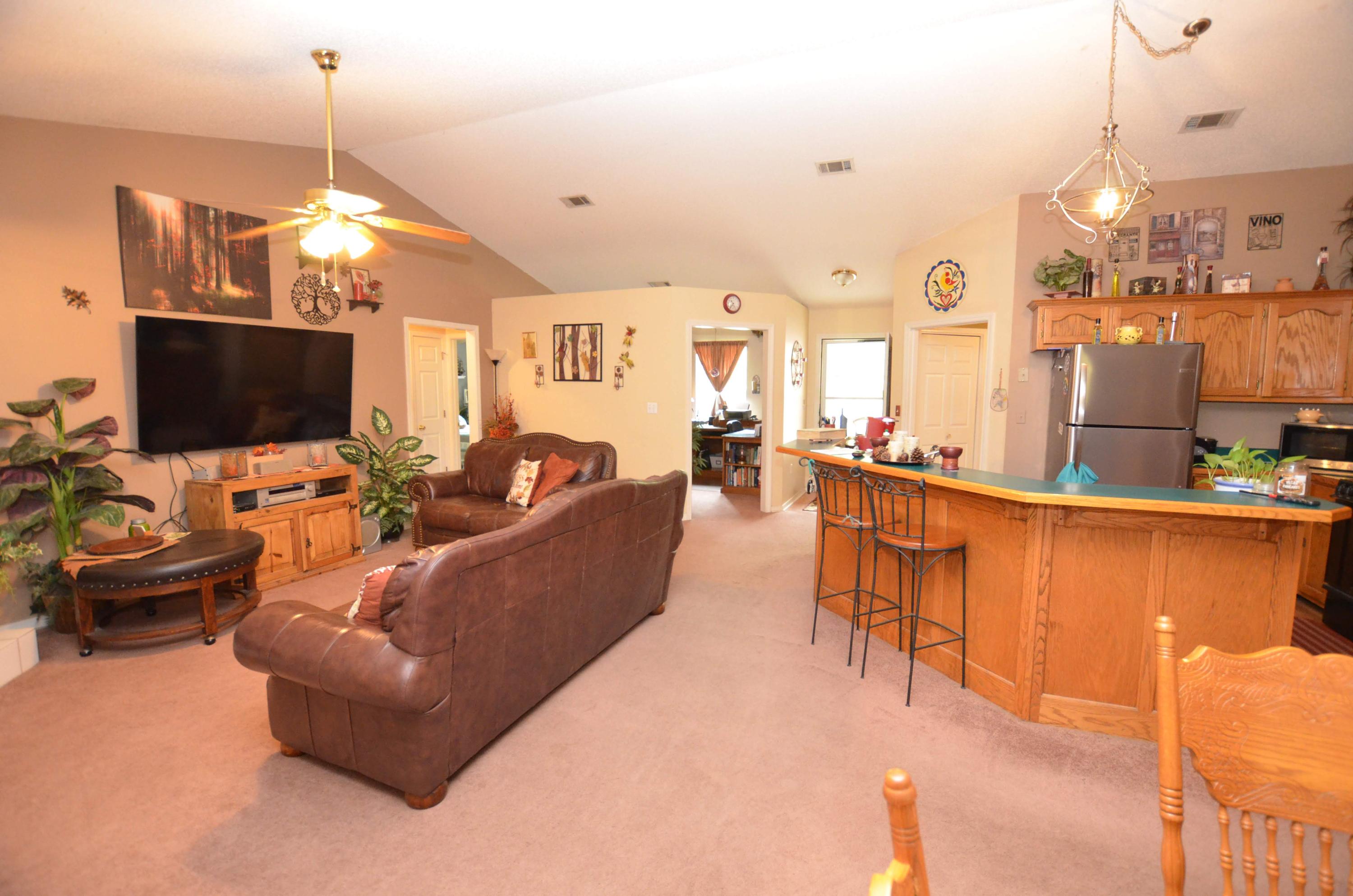 715 Ridge Lake Road Crestview, FL 32536 - Photo 6 of 14 a living room with furniture a flat screen tv and kitchen view