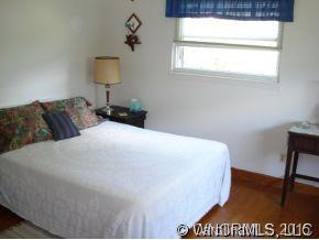 567 Old Newfound Road Leicester, NC 28748 - Photo 6 of 12 a bedroom with a bed and a table in it