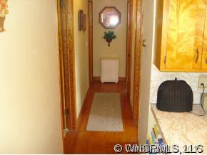 567 Old Newfound Road Leicester, NC 28748 - Photo 8 of 12 a view of a hallway with wooden floor and a bathroom