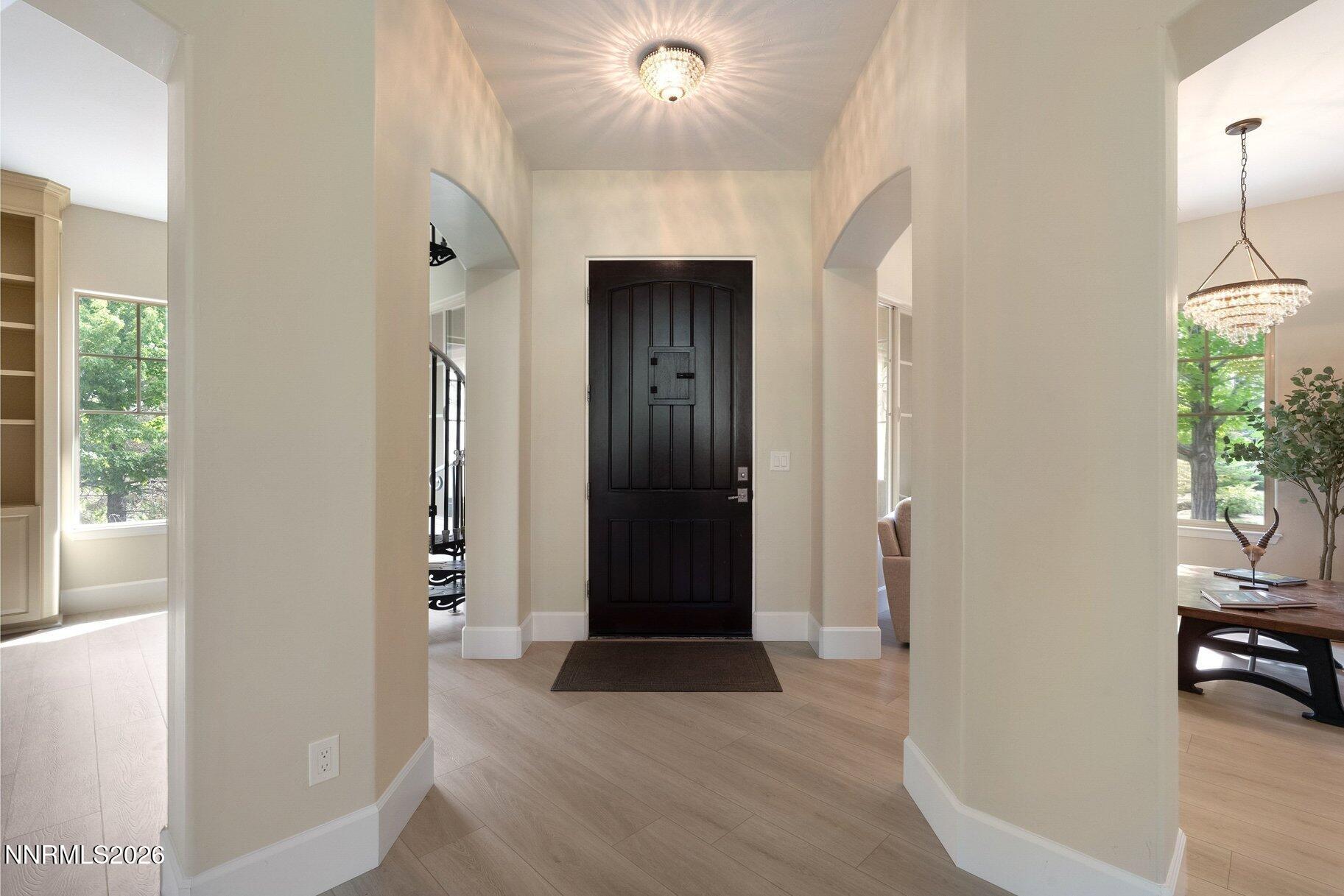 16925 Rue Du Parc Reno, NV 89511 - Photo 6 of 34 a view of a hallway with wooden floor and windows