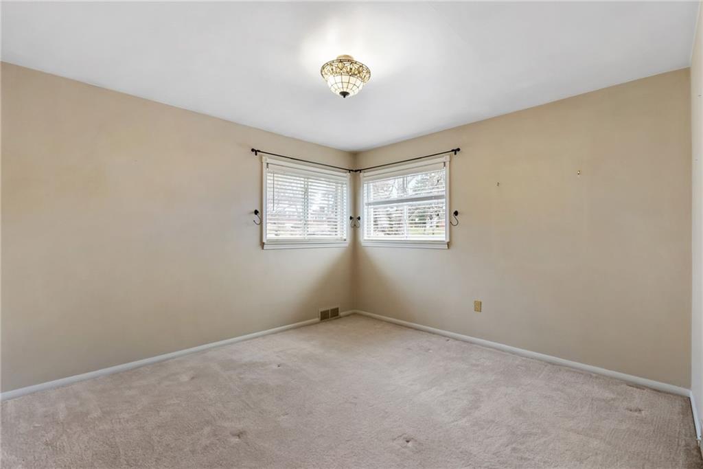 107 Marshall Drive Coraopolis, PA 15108 - Photo 20 of 32 an empty room with windows and chandelier fan