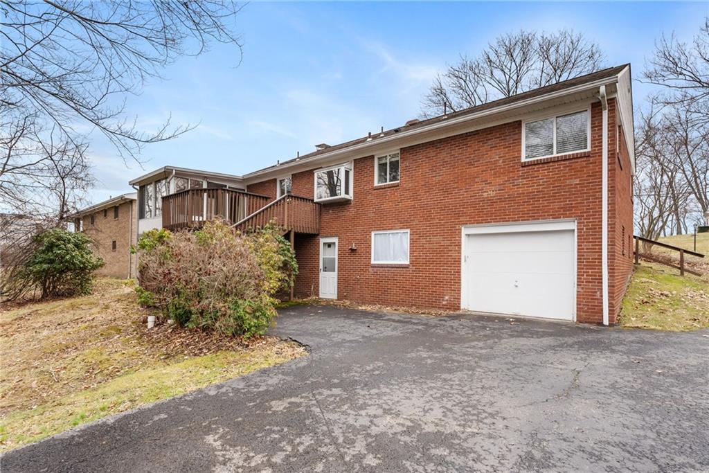 107 Marshall Drive Coraopolis, PA 15108 - Photo 30 of 32 a front view of a house with a yard and garage