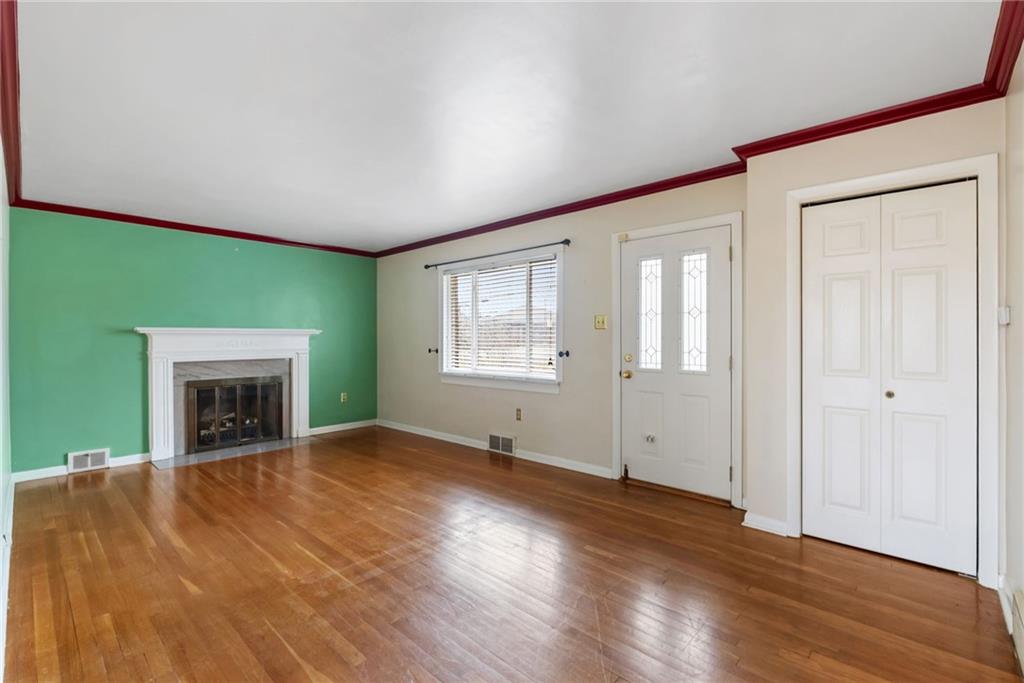 107 Marshall Drive Coraopolis, PA 15108 - Photo 5 of 32 an empty room with windows and a fireplace
