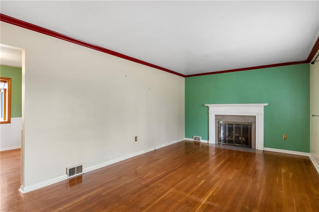 107 Marshall Drive Coraopolis, PA 15108 - Photo 7 of 32 a view of an empty room with wooden floor and a fireplace