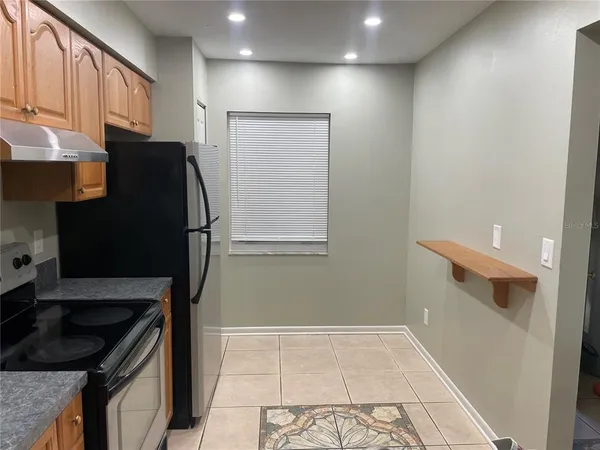 a kitchen with a refrigerator and a stove