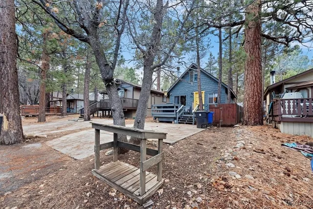 a wooden bench sitting in front of house