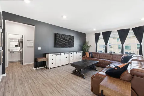 a living room with furniture and wooden floor
