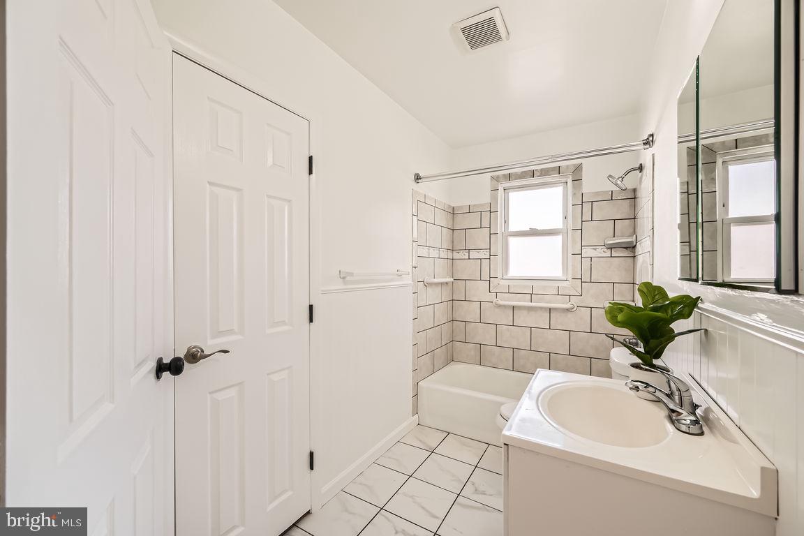 317 Townsend Road Essex, MD 21221 - Photo 13 of 28 a bathroom with a sink a toilet a tub and shower