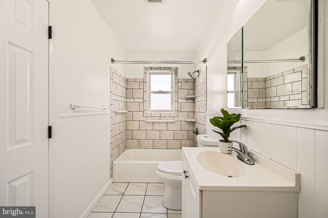 317 Townsend Road Essex, MD 21221 - Photo 14 of 28 a bathroom with a sink a toilet and shower