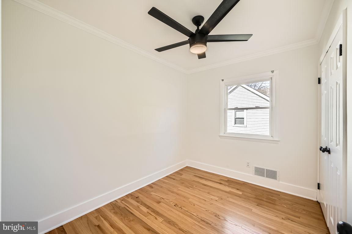 317 Townsend Road Essex, MD 21221 - Photo 16 of 28 an empty room with wooden floor and windows