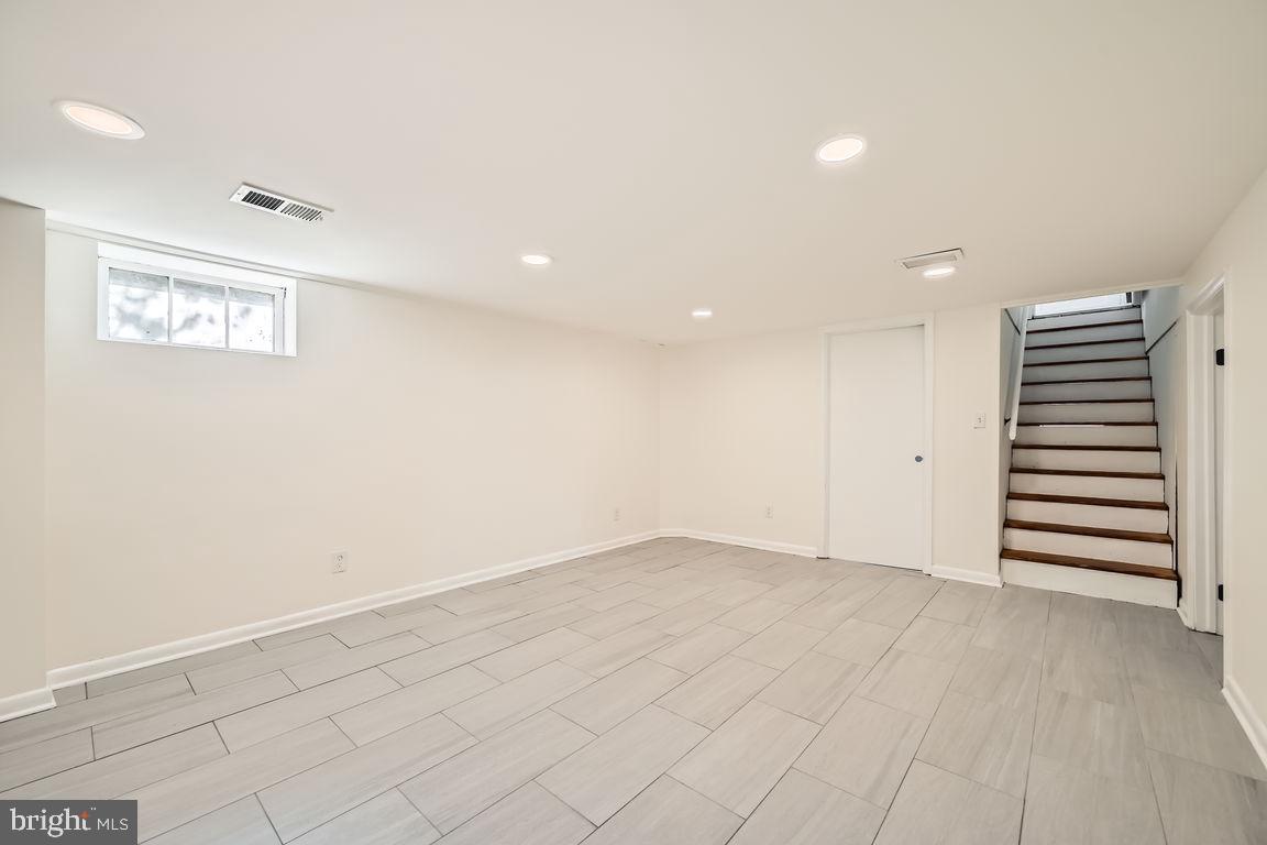 317 Townsend Road Essex, MD 21221 - Photo 17 of 28 an empty room with a hallway and stairs