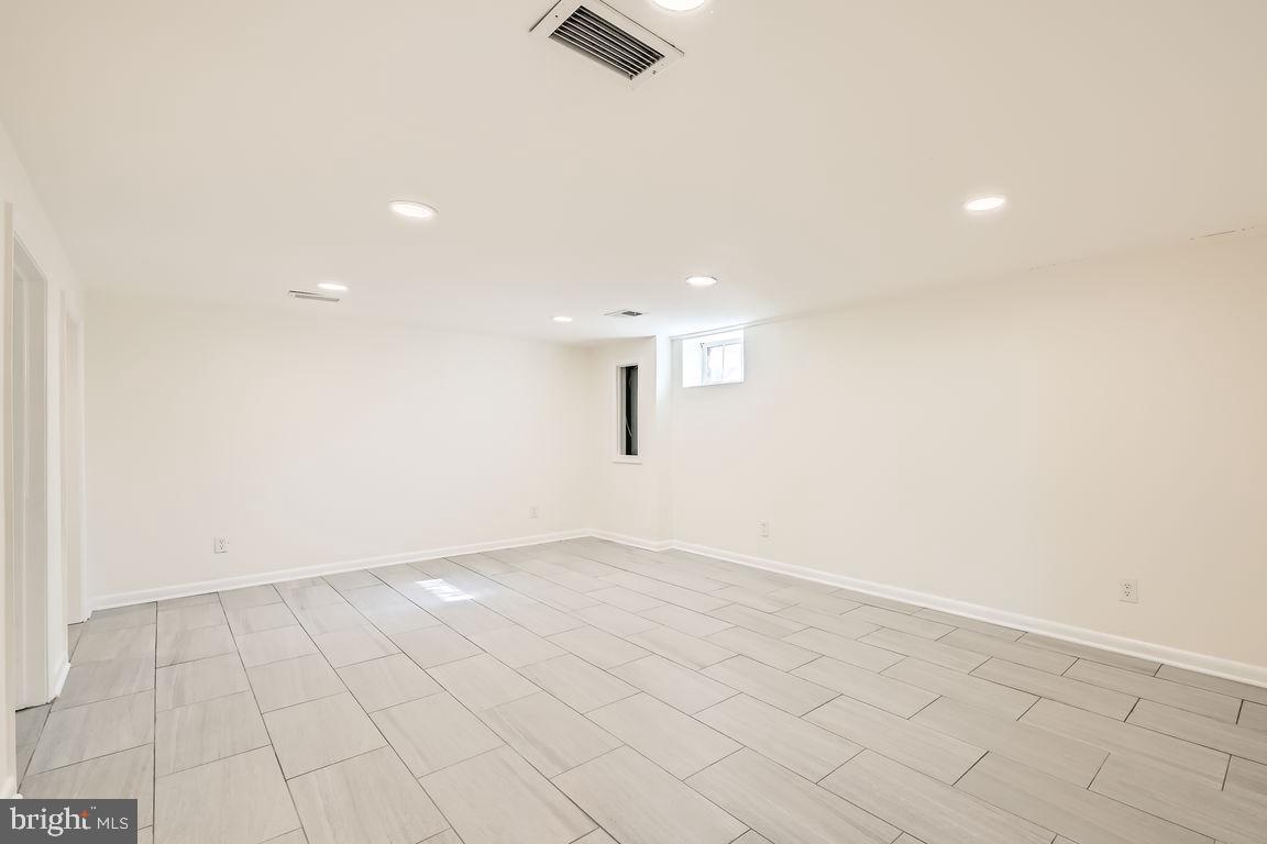 317 Townsend Road Essex, MD 21221 - Photo 18 of 28 an empty room with white walls and tiles