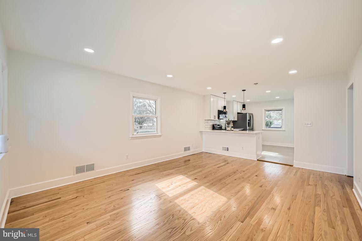 317 Townsend Road Essex, MD 21221 - Photo 4 of 28 a view of kitchen and empty room with wooden floor
