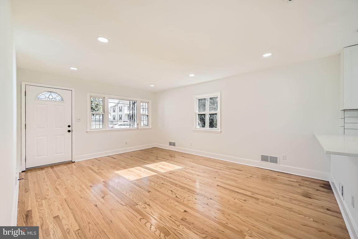 317 Townsend Road Essex, MD 21221 - Photo 5 of 28 a view of empty room with wooden floor and fan