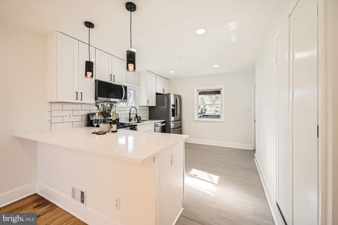 317 Townsend Road Essex, MD 21221 - Photo 7 of 28 a view of kitchen with stainless steel appliances granite countertop refrigerator sink and cabinets