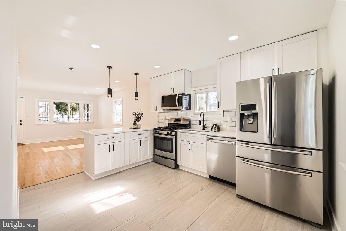 317 Townsend Road Essex, MD 21221 - Photo 8 of 28 a kitchen with granite countertop stainless steel appliances and wooden cabinets
