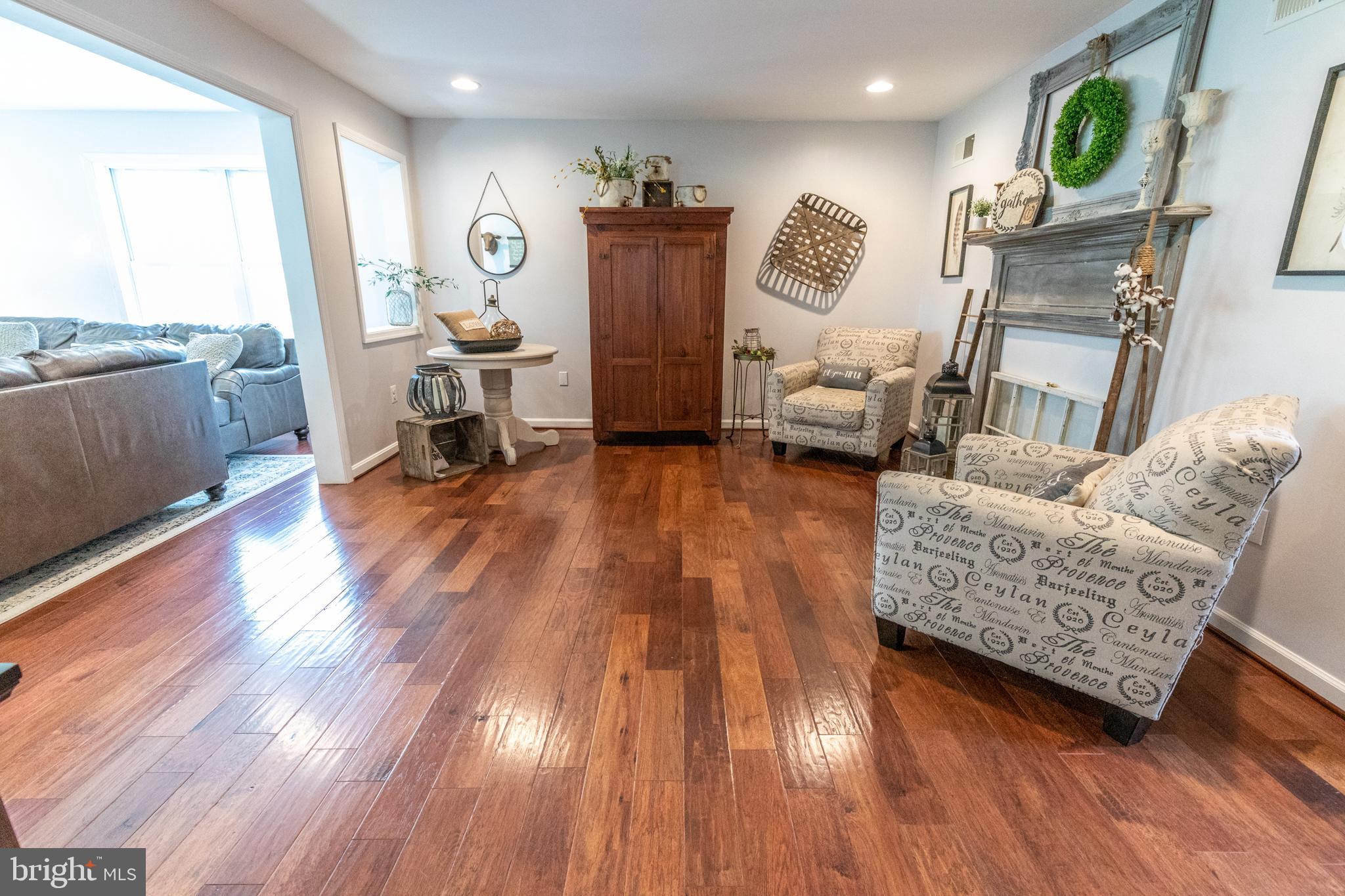 193 Quail Run Road Summit Point, WV 25446 - Photo 32 of 72 a living room with furniture and a wooden floor