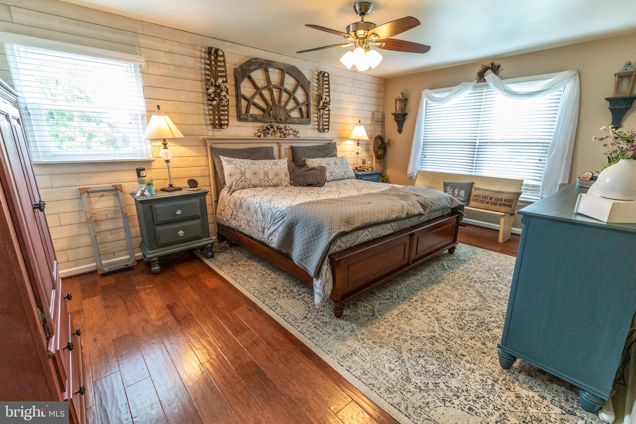 193 Quail Run Road Summit Point, WV 25446 - Photo 51 of 72 a bedroom with a bed a dresser next to a window