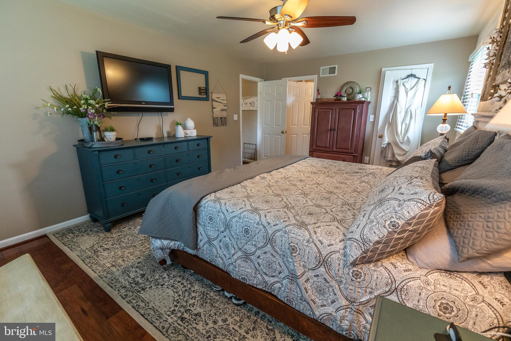 193 Quail Run Road Summit Point, WV 25446 - Photo 53 of 72 a bedroom with a bed and a flat screen tv