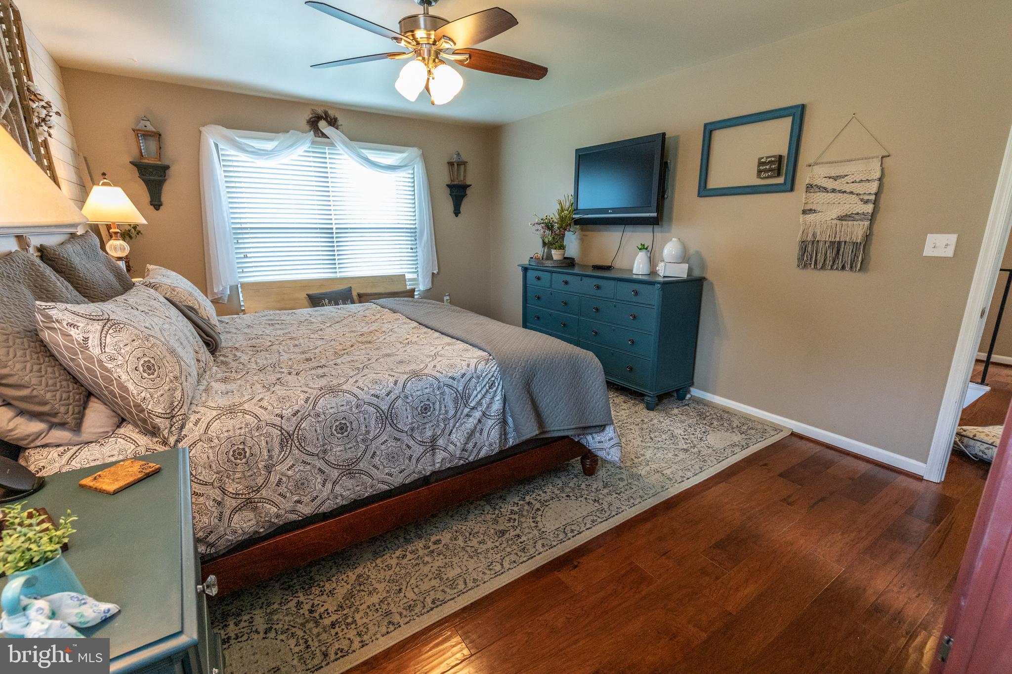193 Quail Run Road Summit Point, WV 25446 - Photo 54 of 72 a bedroom with a bed and wooden floor