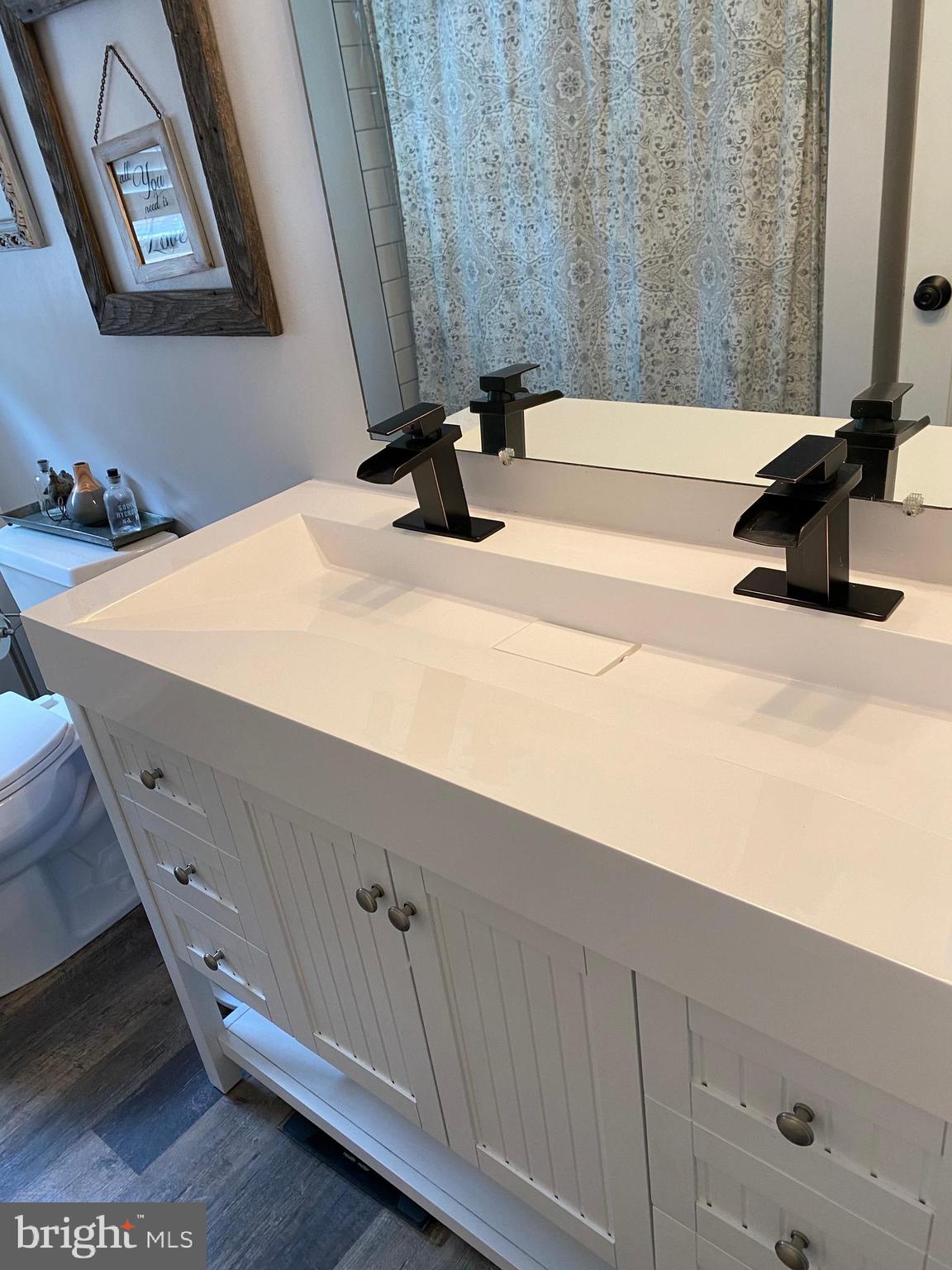 193 Quail Run Road Summit Point, WV 25446 - Photo 56 of 72 a bathroom with a sink and a mirror